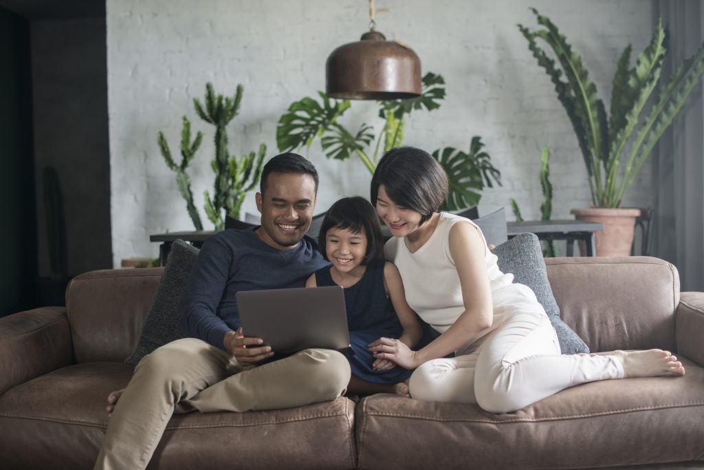 Family looking at the computer at home.