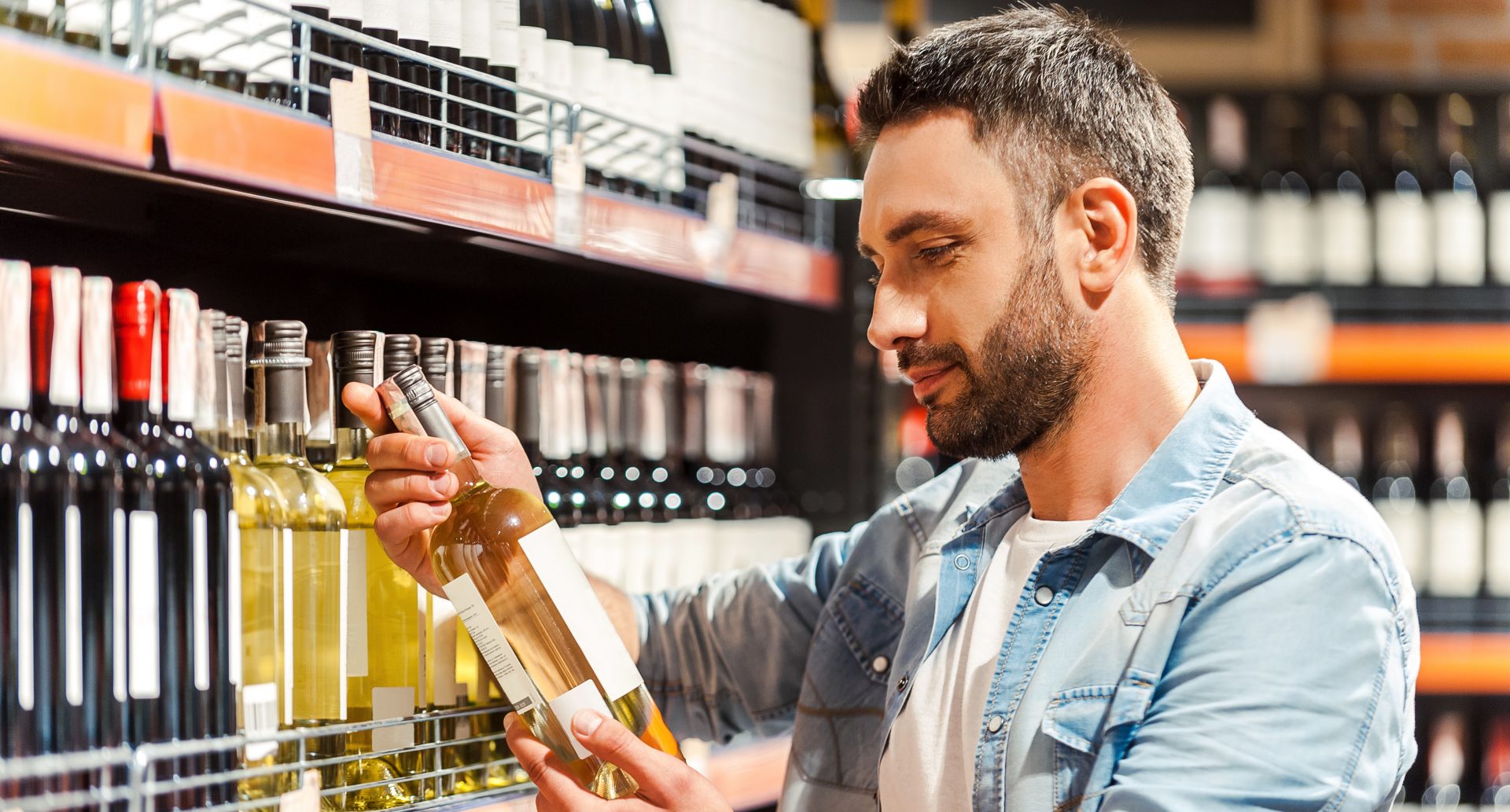 young man holding wine